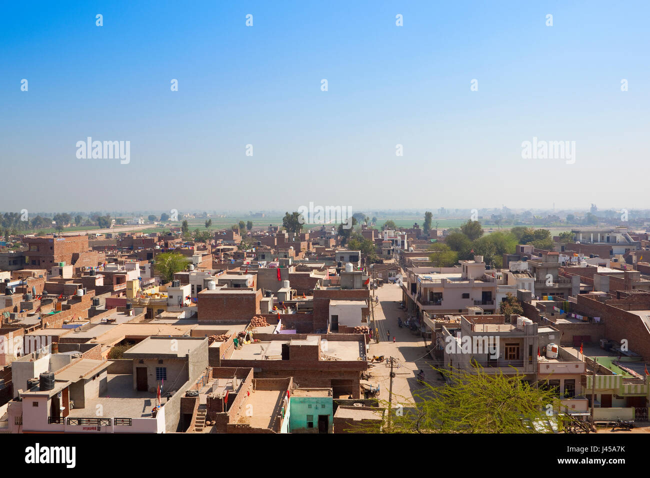 daily life in hanumangarh city with houes and shops and a view of distant countryside from bhatner fort in rajasthan india under a blue sky Stock Photo