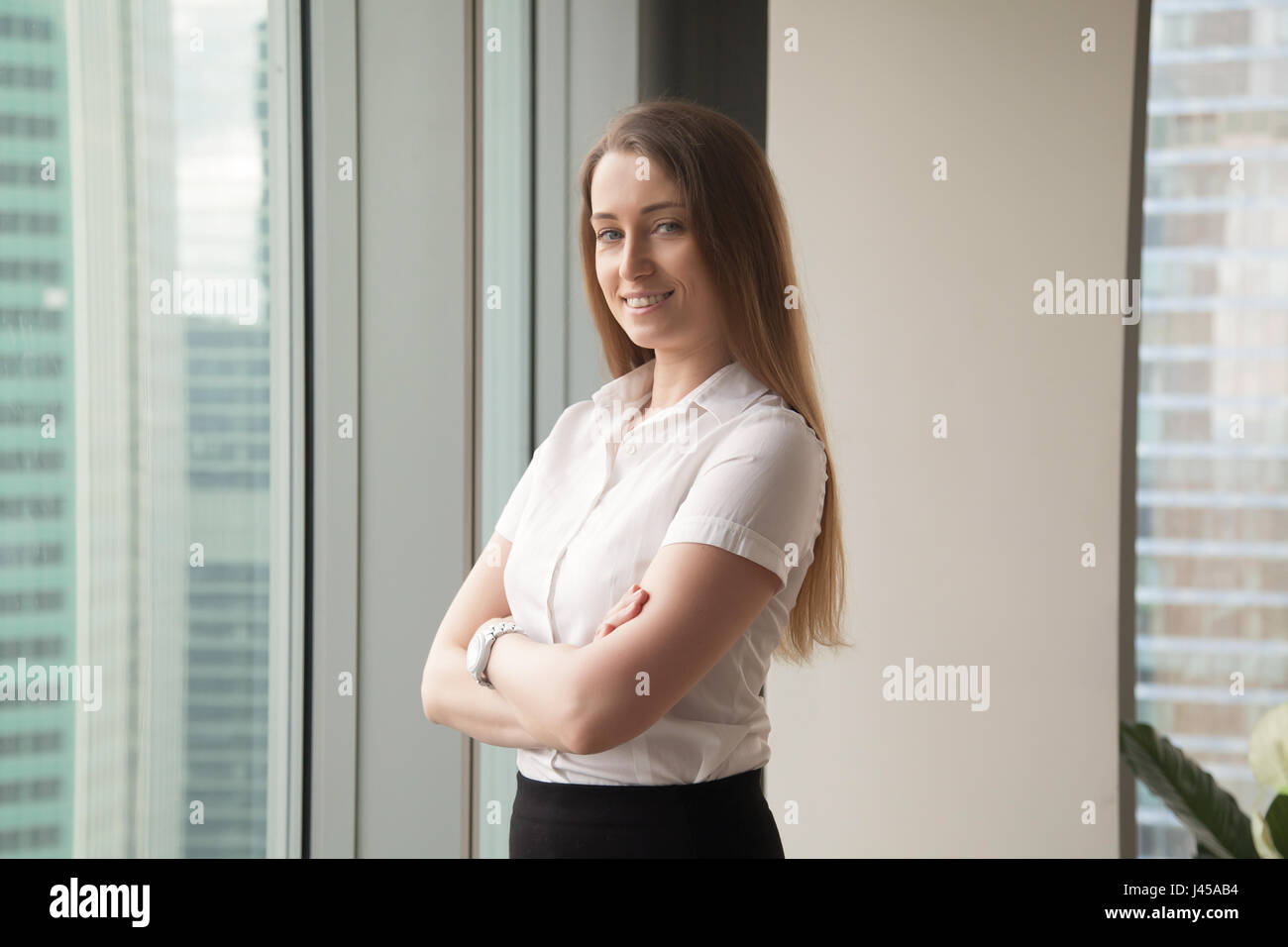 Confident young businesswoman enjoys success Stock Photo