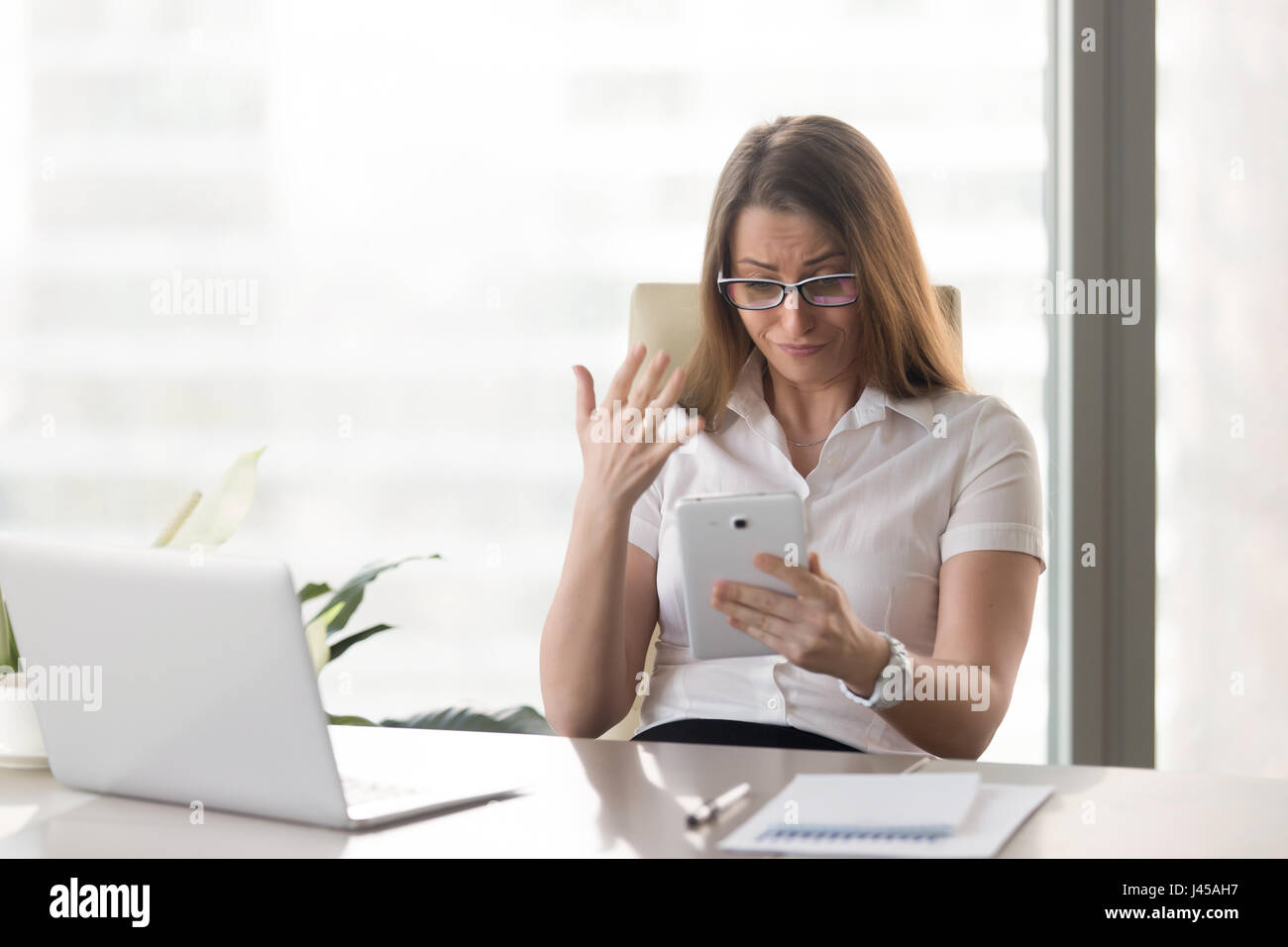 Businesswoman disappointed bad financial results Stock Photo
