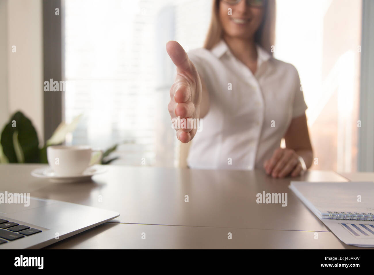 Businesswoman welcomes partner on business meeting Stock Photo