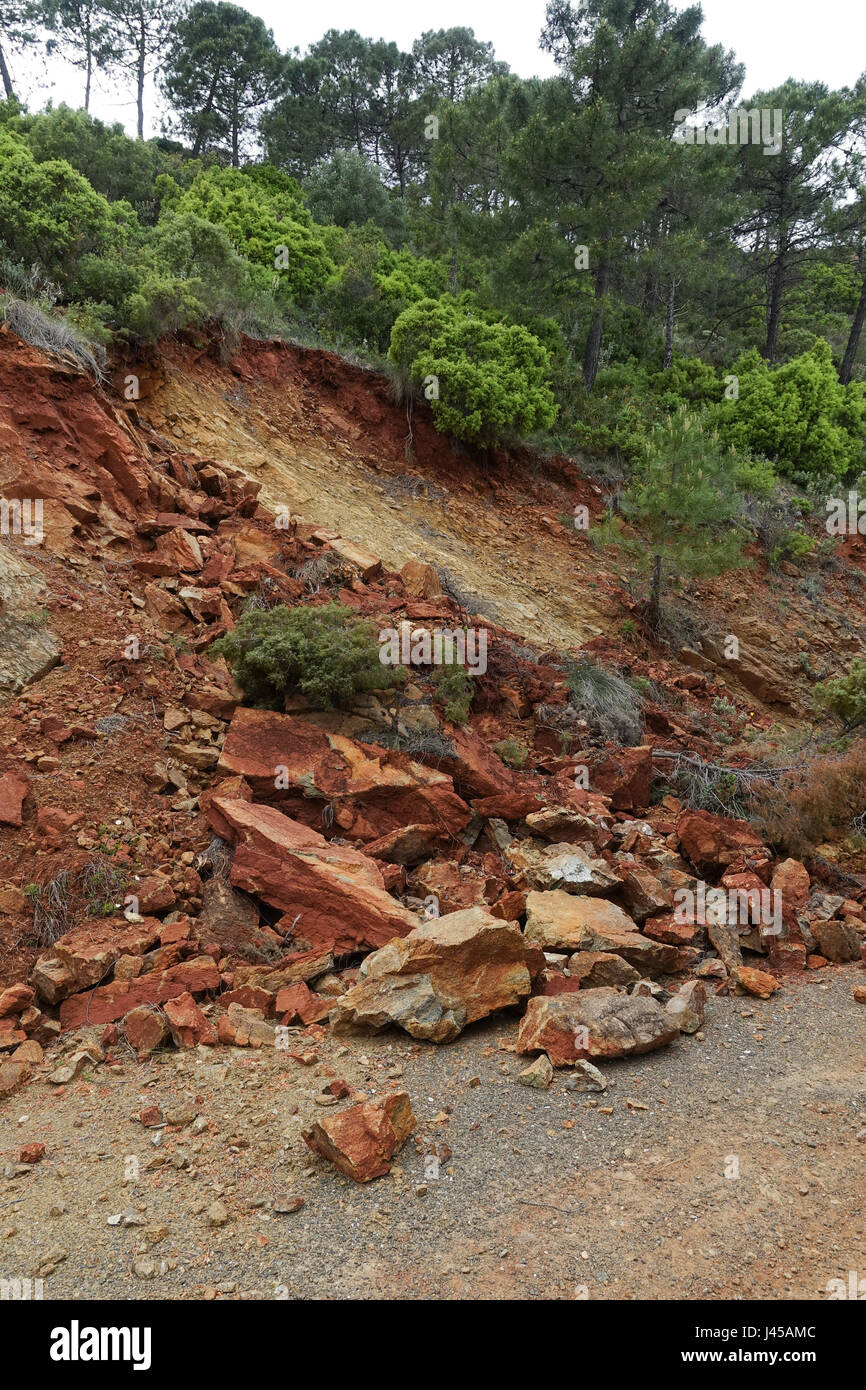 Small landslide on side of steep hill, after heavy rainfall, showing Peridotite rocks, mountains in Spain Stock Photo
