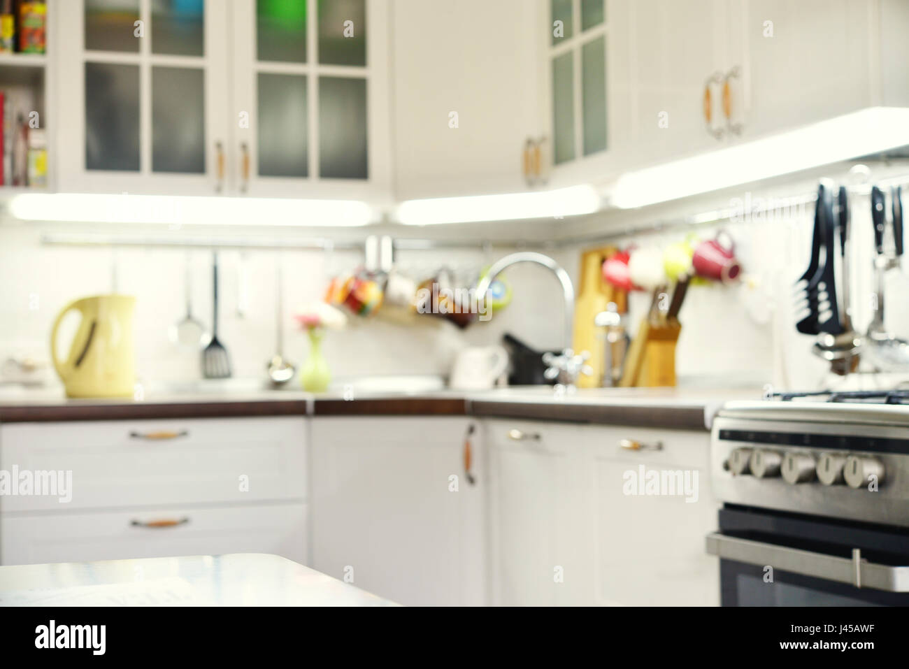 Blurred background. Modern kitchen with railings system  and kitchen utensils. Stock Photo