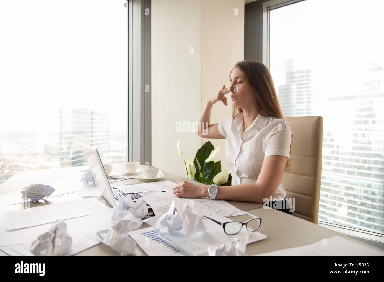 Tired businesswoman want kill herself at workplace Stock Photo