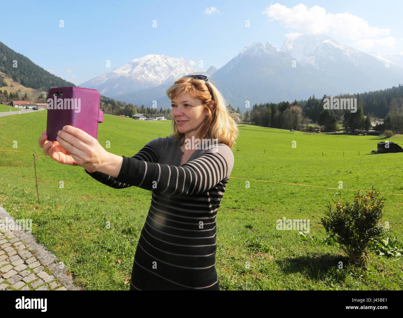 Adult Woman 50-55 Years taking selfie in Front of the Alps, Bavaria , Germany Stock Photo