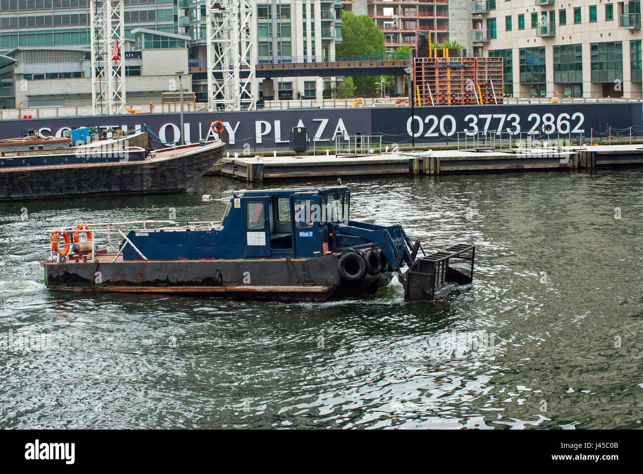 London, UK,, 08/05/2017 Boat cleaning rubbish from South Dock on the