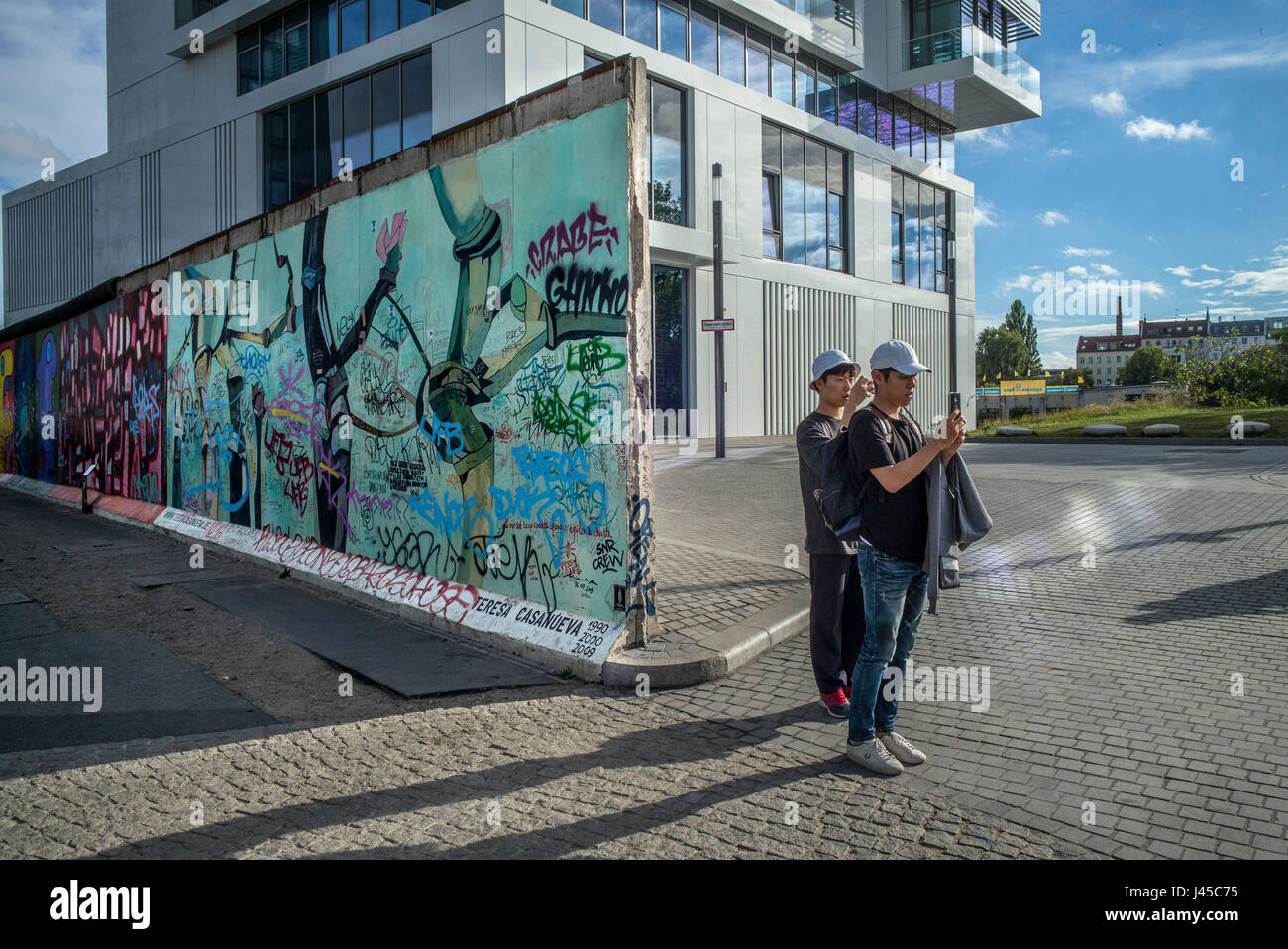A section of the East Side Gallery on Mühlenstrasse, Berlin, site of the few last remaining parts of the Berlin Wall adorned by various artists and gr Stock Photo