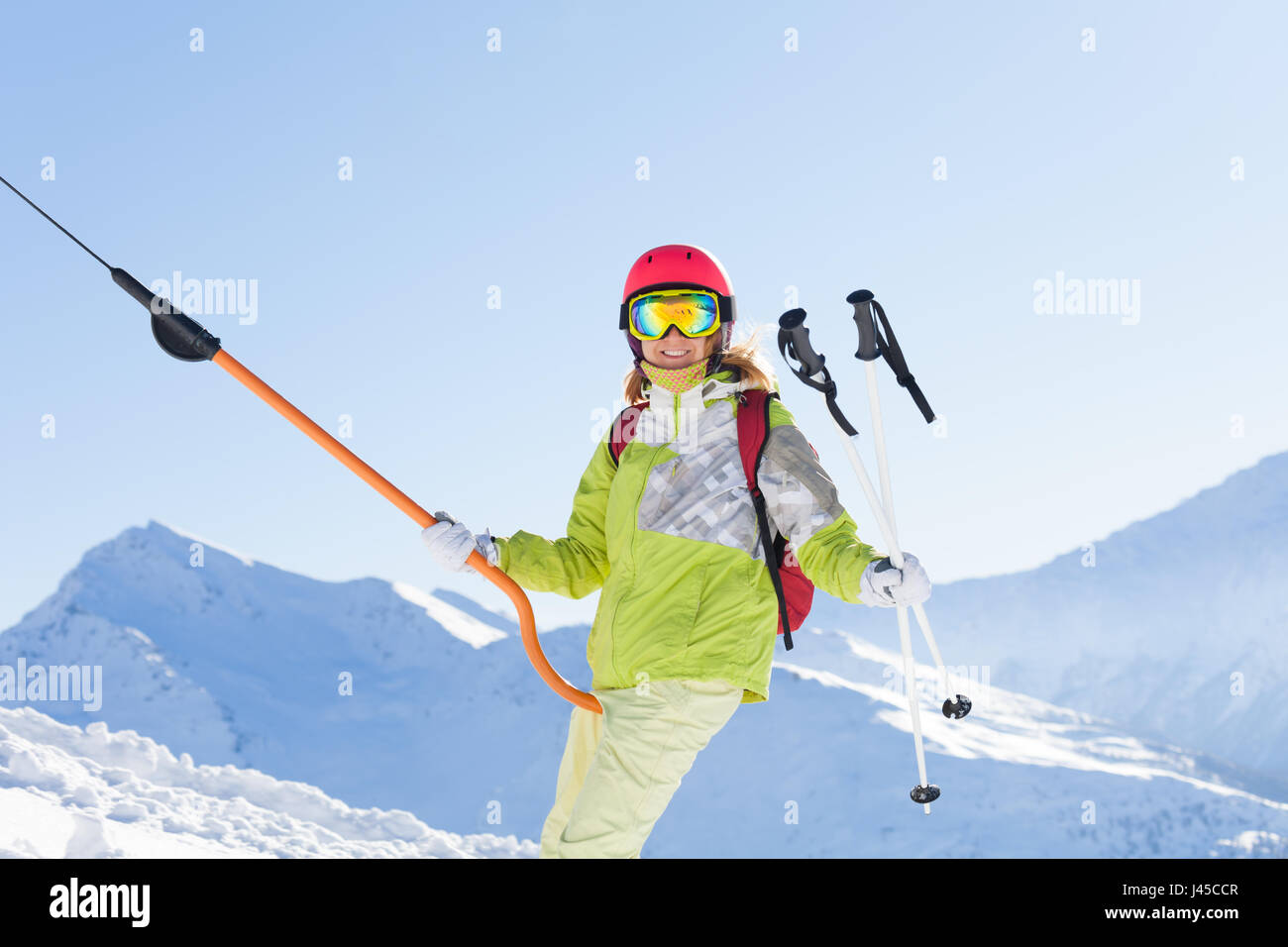 Smiling woman in ski suit lifting on button lift Stock Photo Alamy