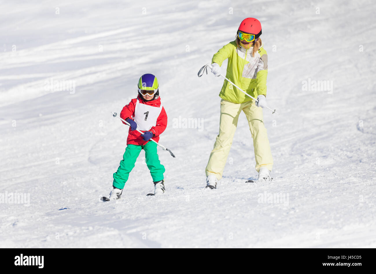 Little boy training skiing with female instructor Stock Photo