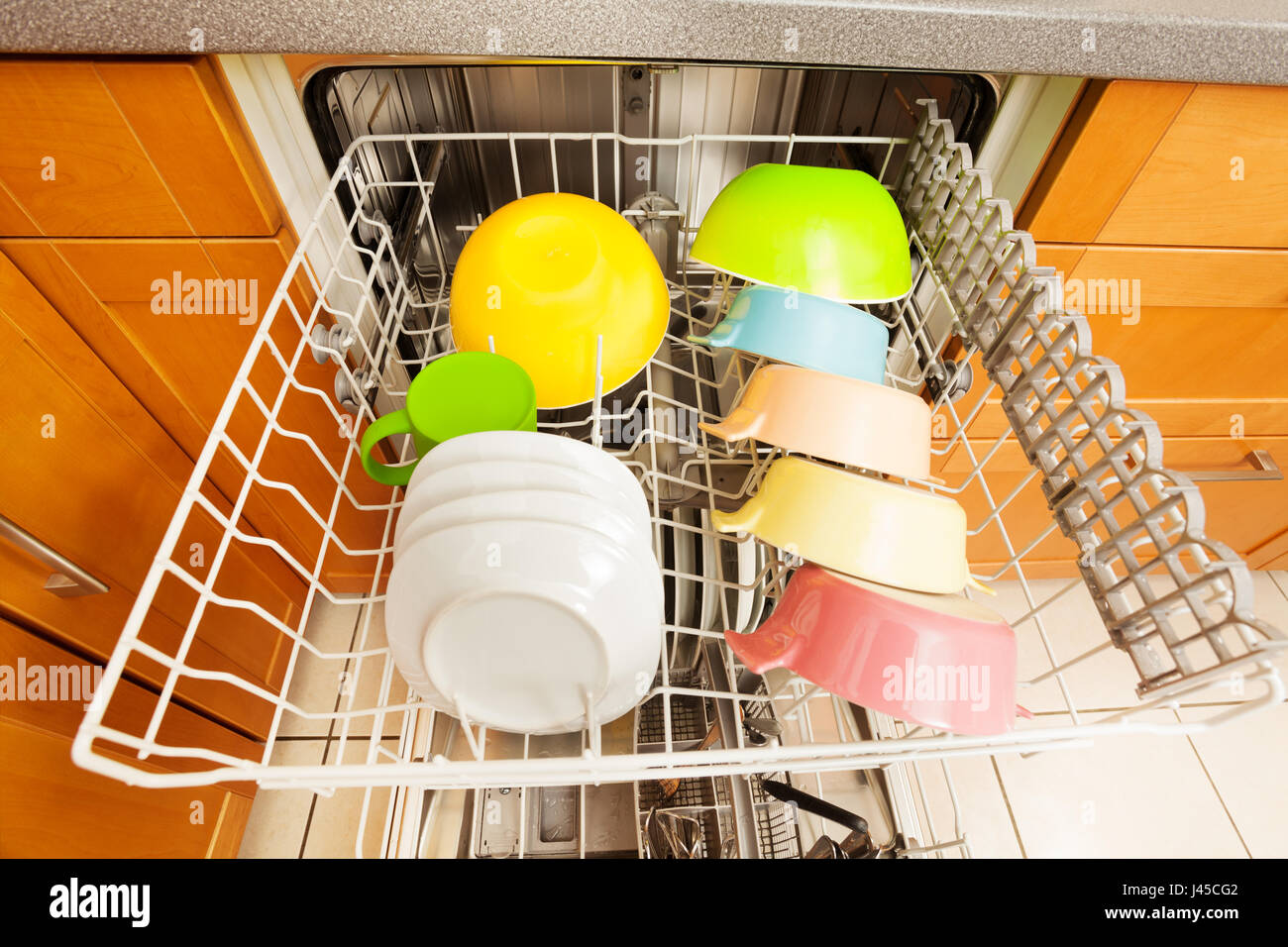 Dishwasher with clean utensils drying in it's rack Stock Photo Alamy