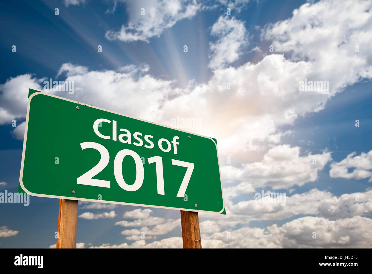 Class of 2017 Green Road Sign with Dramatic Clouds and Sky. Stock Photo