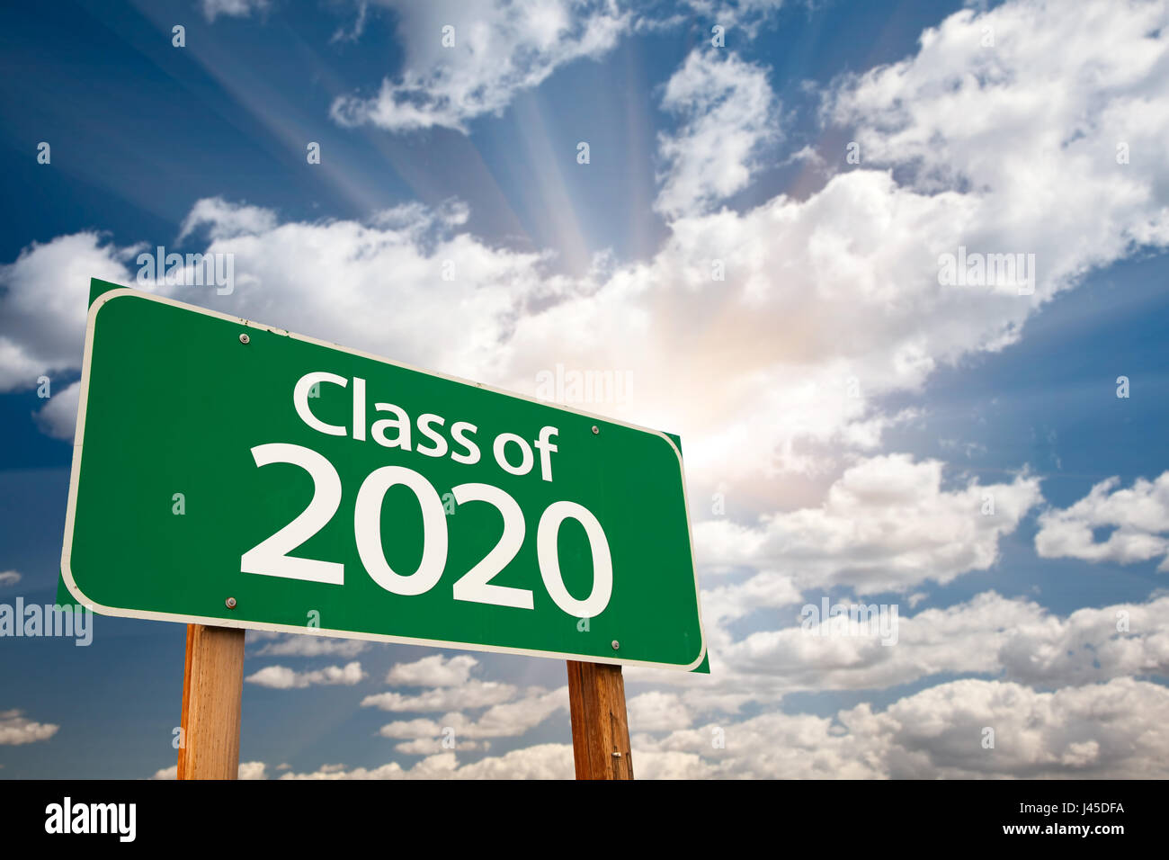 Class of 2020 Green Road Sign with Dramatic Clouds and Sky. Stock Photo