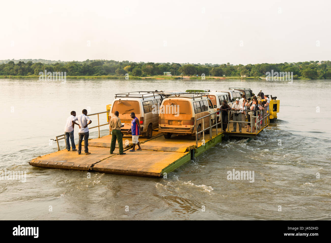 A small vehicle ferry transporting vehicles and people across the Victoria Nile river at Paraa in Murchison Falls National Park, Uganda Stock Photo