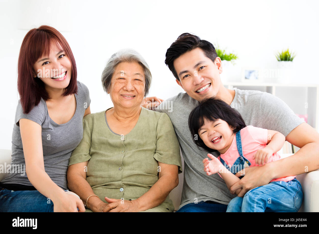 happy little girl with her grandmother and parents Stock Photo - Alamy