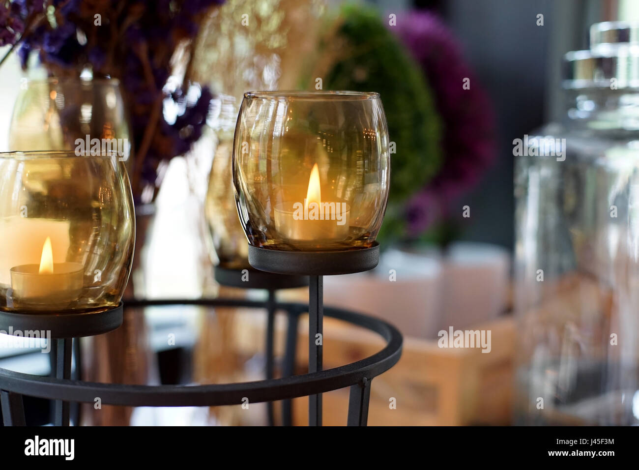 candles lit in brown glass, interior decoration Stock Photo Alamy