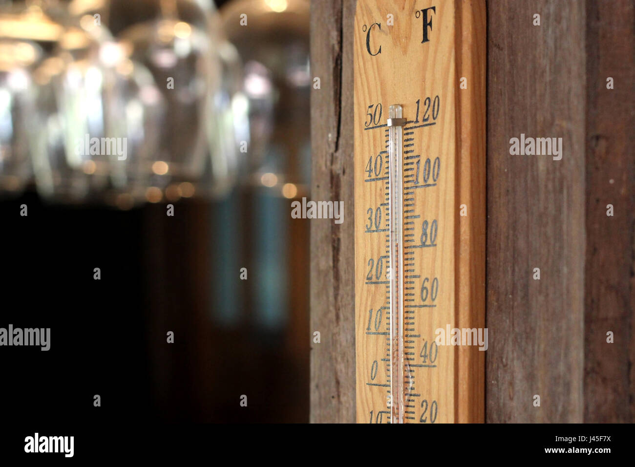 thermometer on wooden wall in restaurant Stock Photo