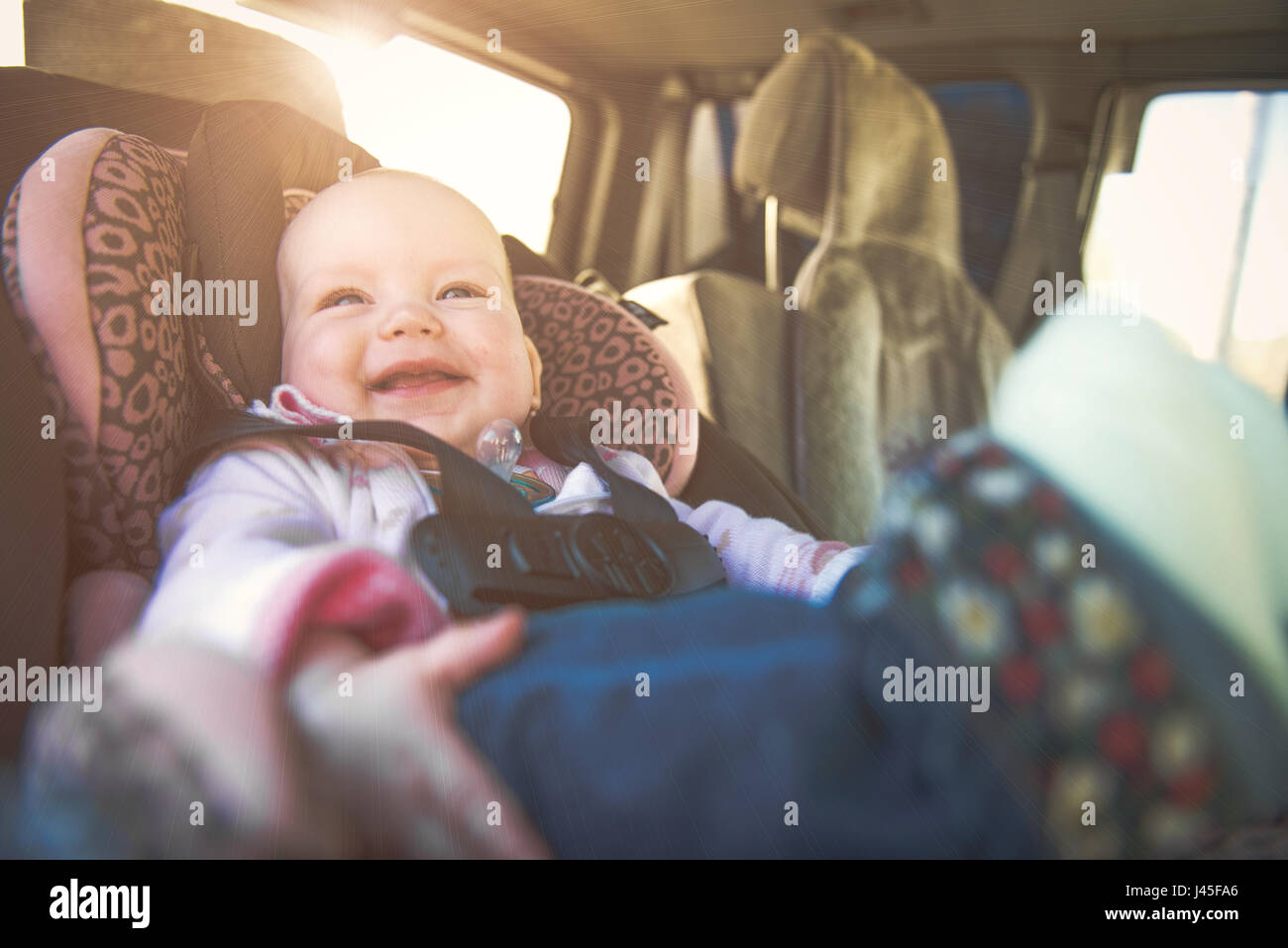 Cute toddler boy sitting in car seat Stock Photo