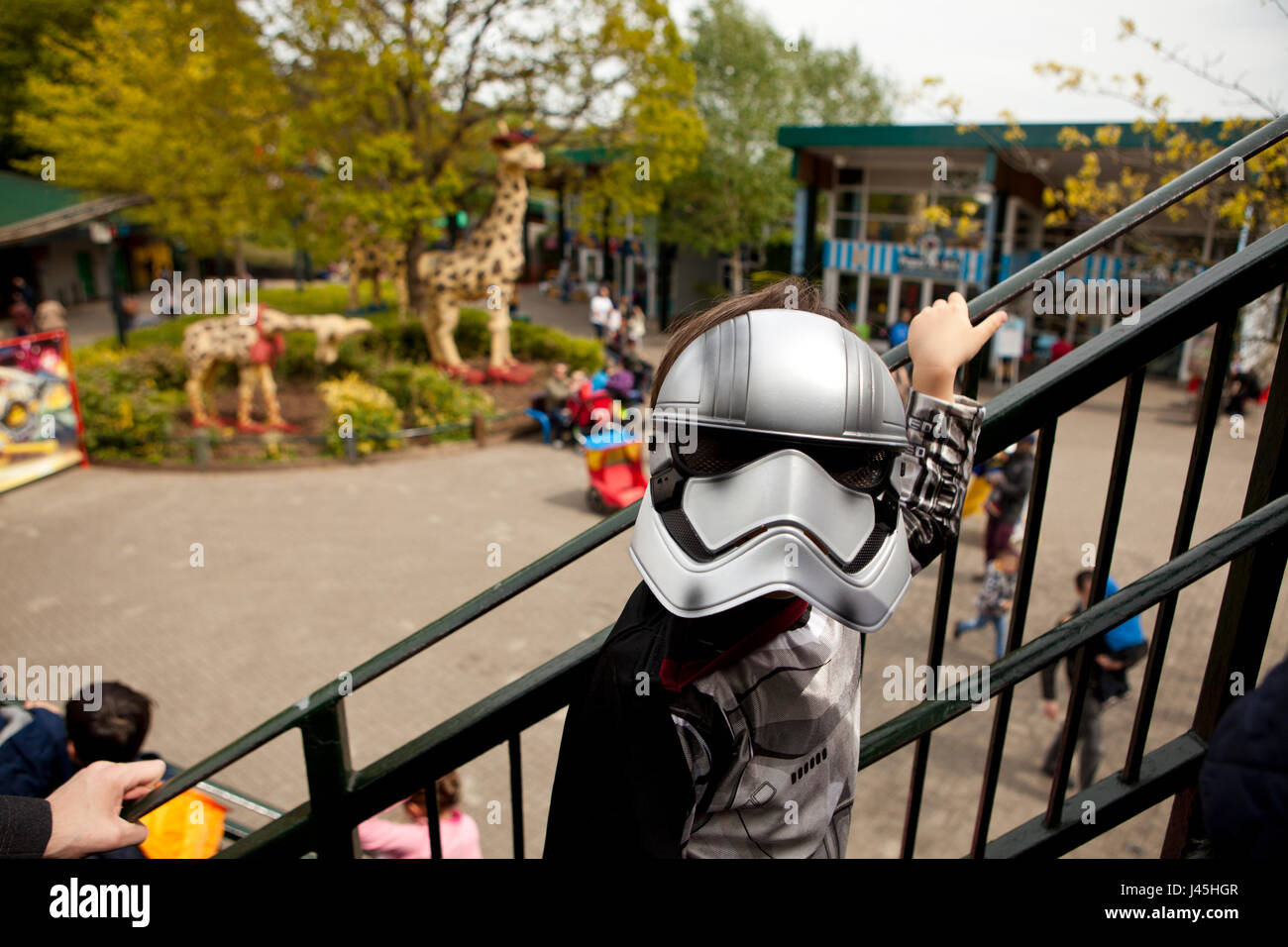National Star Wars day parade at Legoland UK Berkshire a boy dressed as captain Phasma waiting in a queue to get on a ride Stock Photo