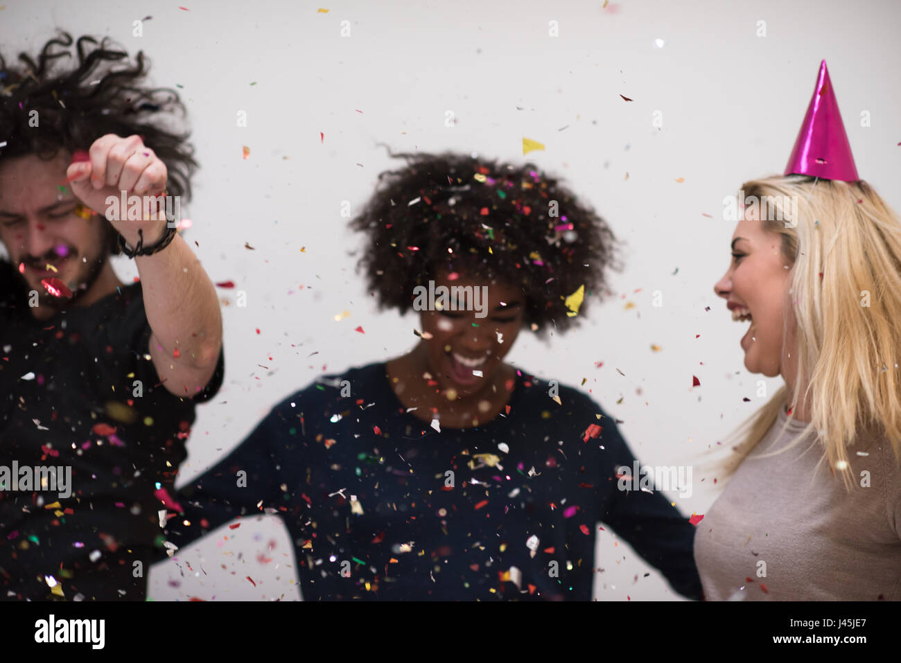 confetti party Multiethnics happy young people group celebrating new ...