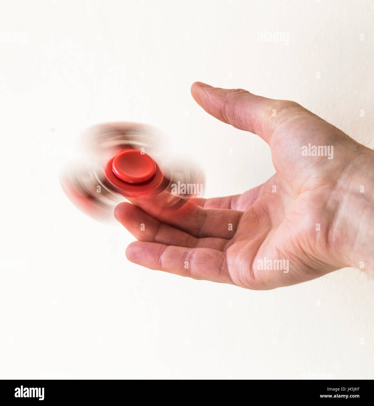 Hand spinner fidget finger toy spinning on a finger Stock Photo