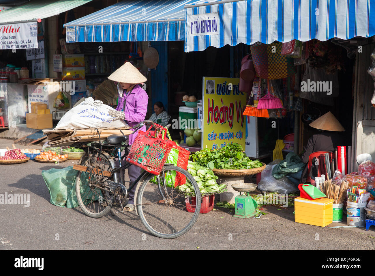 NHA TRANG, VIETNAM - DECEMBER 18: Vietnamese women in traditional conical hat at the wet market on December 18, 2015 in Nha Trang, Vietnam. Stock Photo