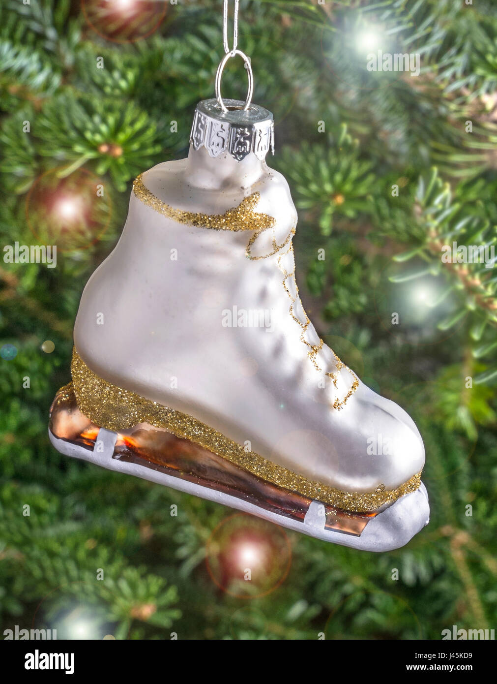 Christmas bauble hanging from a tree in the shape of a White Ice Skating Boot Stock Photo