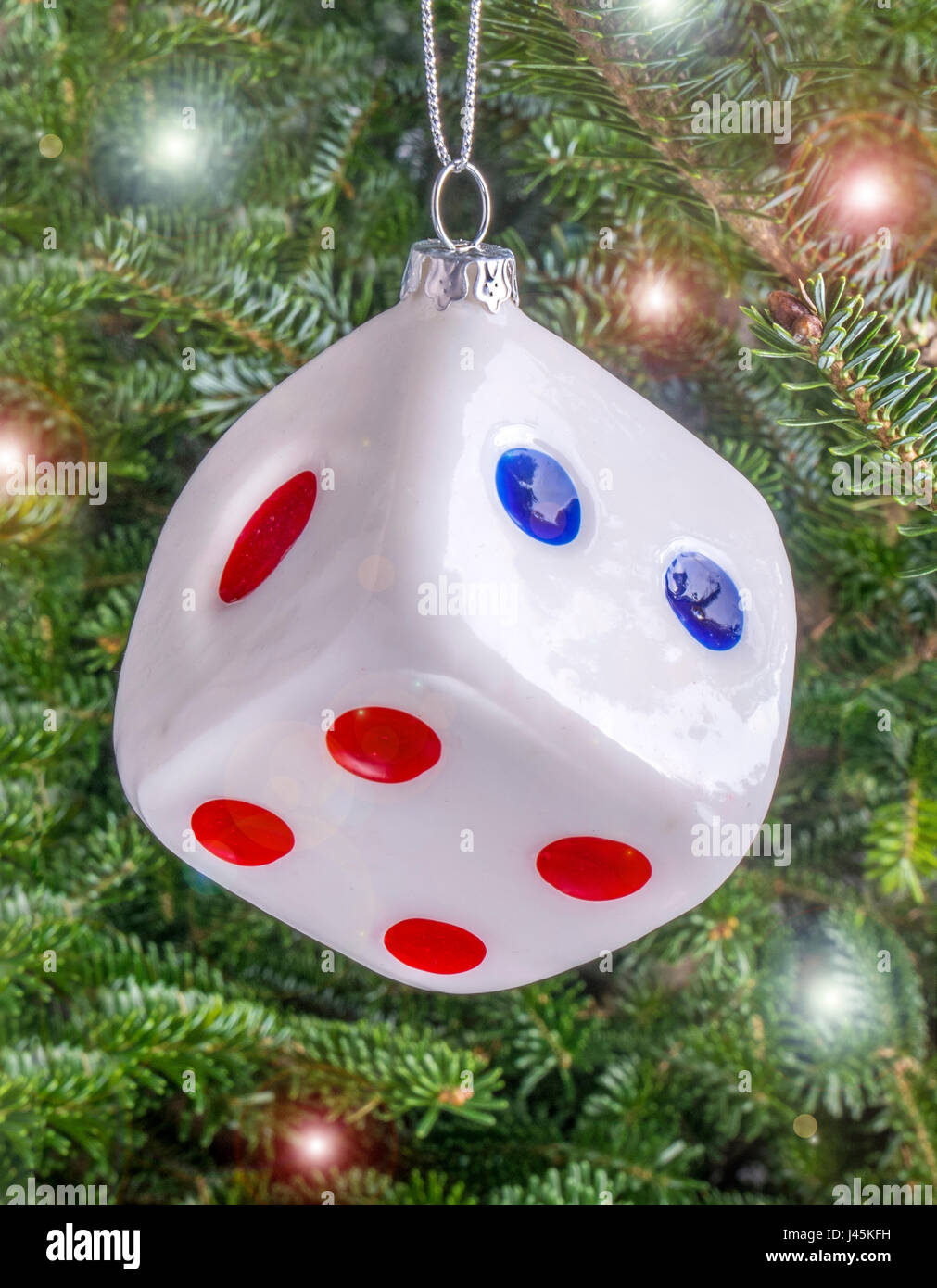 Christmas bauble hanging from a tree in the shape of a Dice Stock Photo