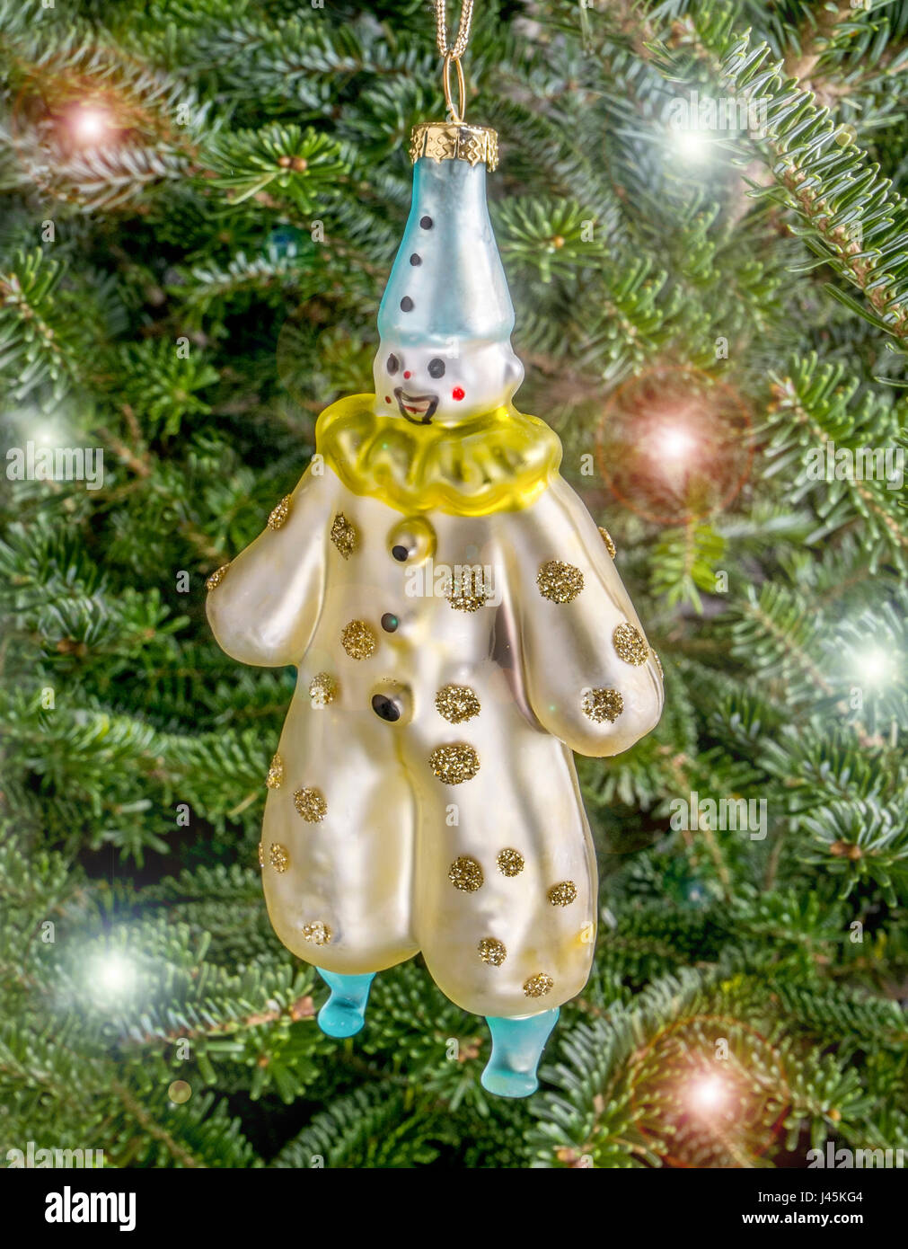 Christmas bauble hanging from a tree in the shape of a Festive Clown Stock Photo