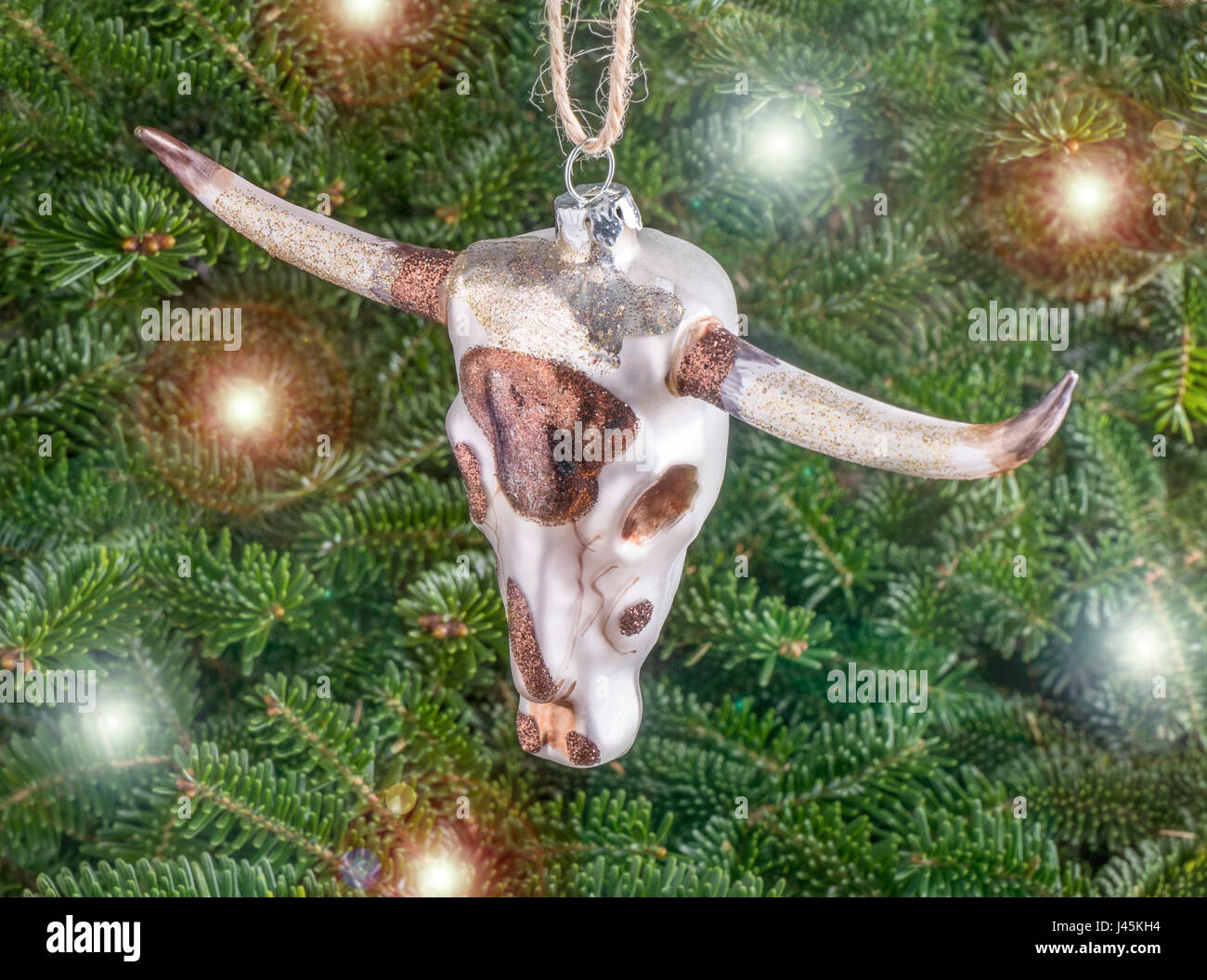 Christmas bauble hanging from a tree in the shape of a Cow with Horns Stock Photo