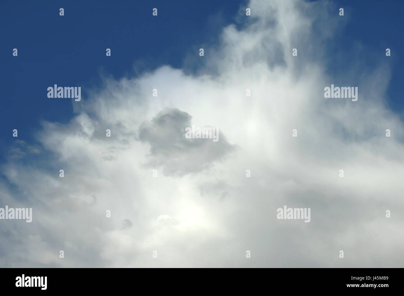 Air and sky is thin and whispy on this clear and sunny day.  Clouds fill two thirds of image. Stock Photo