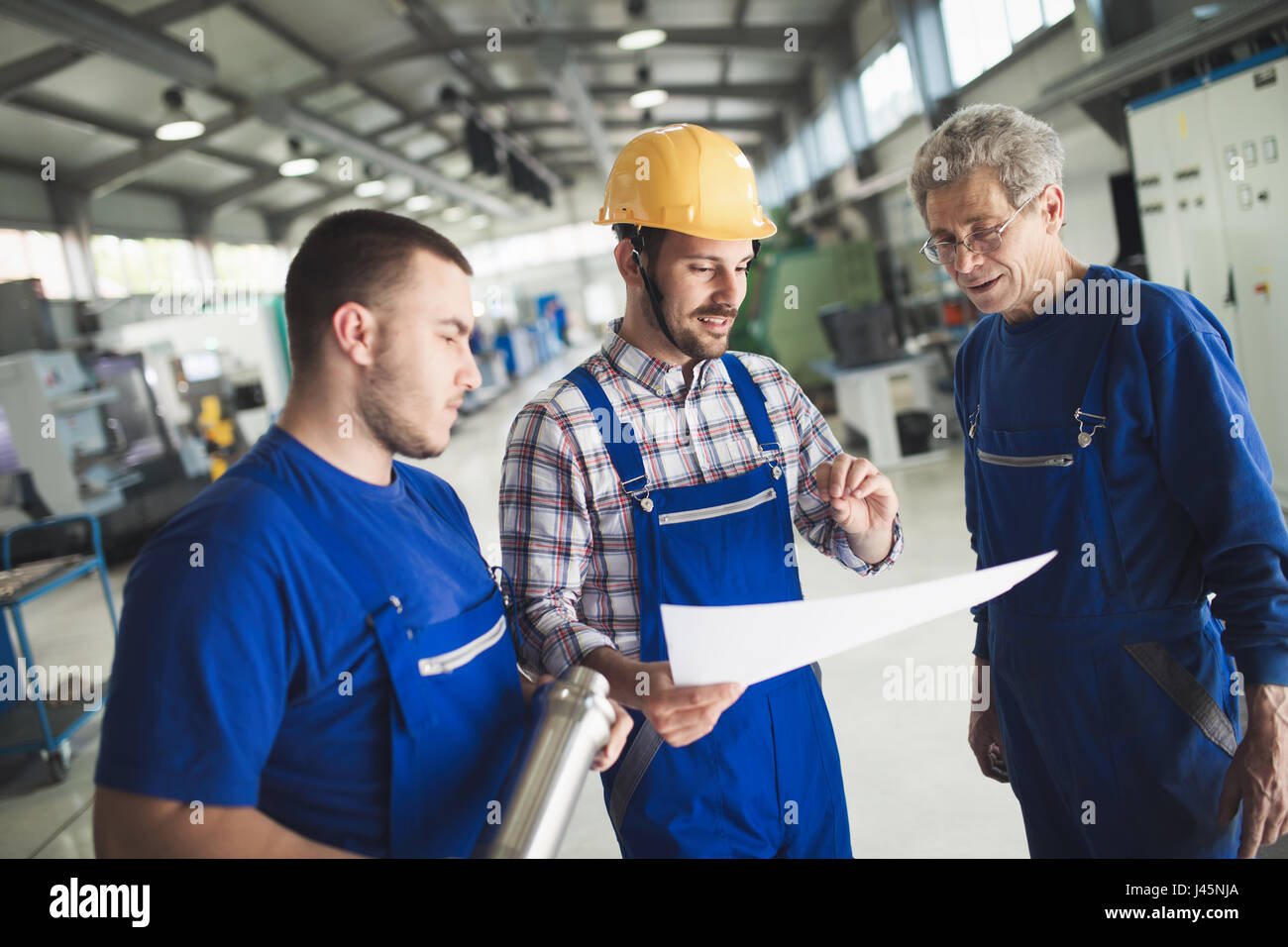 Mechanical and metal industry engineers working in factory Stock Photo