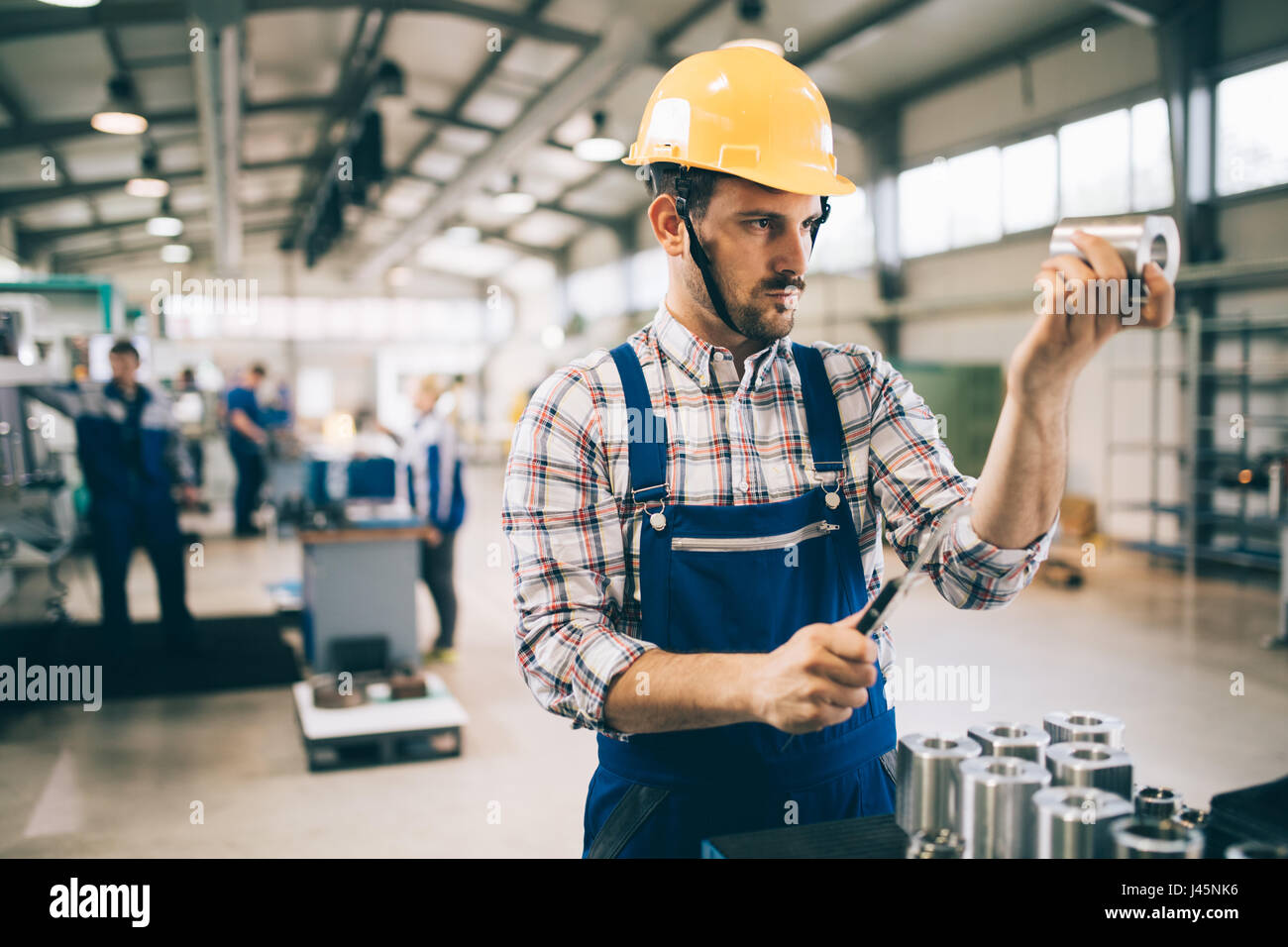 modern industrial machine operator working in metal industry factory ...