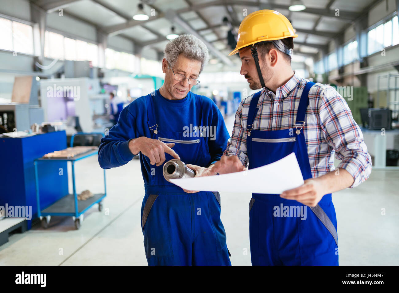 Mechanical and metal industry engineers working in factory Stock Photo