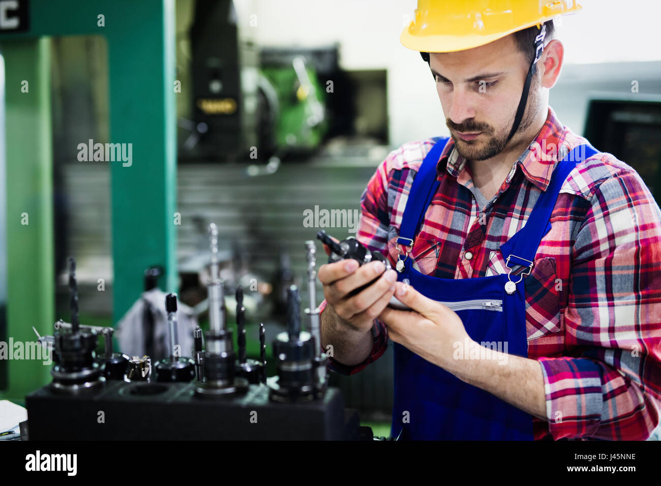 Portrait of an handsome engineer working in metal industry factory Stock Photo