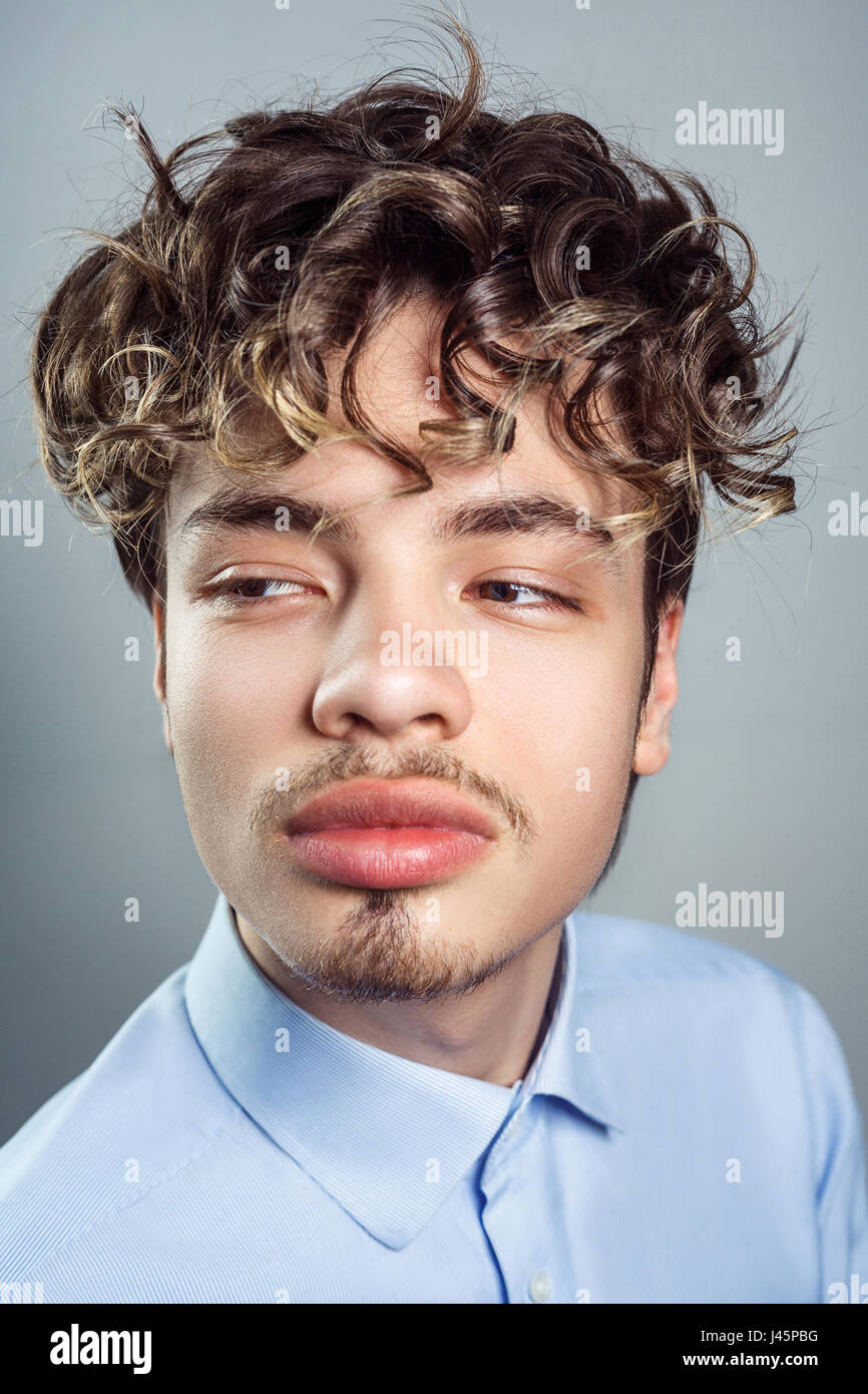 Portrait of young man with curly hairstyle. studio shot. Stock Photo