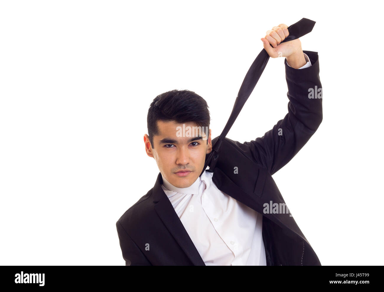 Young man in suit fixing his tie Stock Photo - Alamy