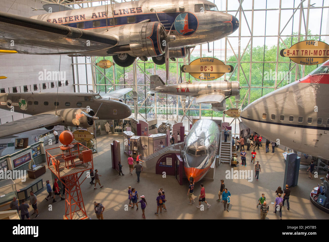 Hisotric passenger planes hang in the National Air and Space Museum in Washington, DC. 1930s era DC-3 is at top, Boeing 747 from the 1970s is at right Stock Photo