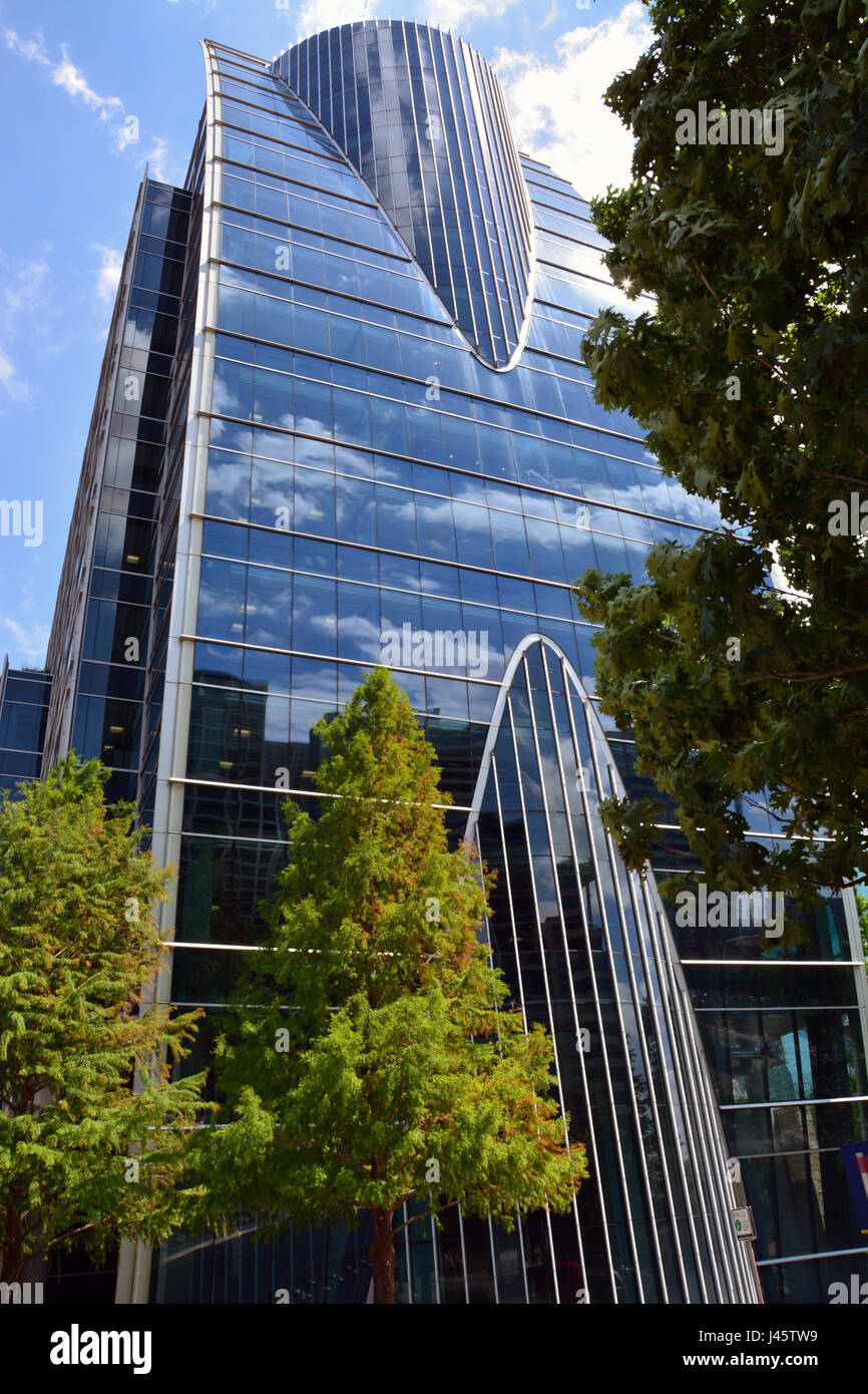 Built in 2007, the Hunt Consolidated Office Tower looms over Klyde Warren Park in the Central Business District of Dallas Stock Photo