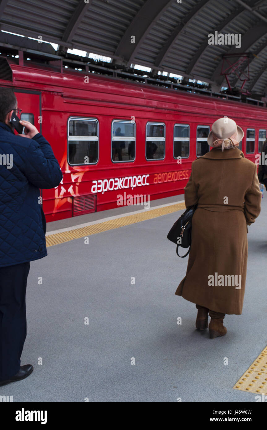 Russia: passengers departing with the red train of Aeroexpress, the only rail link from Domodedovo Airport to the center of Moscow Stock Photo