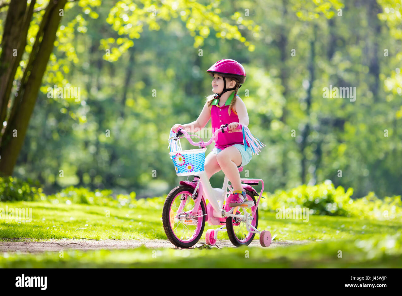 Child riding bike. Kid on bicycle in sunny park. Little girl enjoying bike  ride on her way to school on warm summer day. Preschooler learning to balan  Stock Photo - Alamy