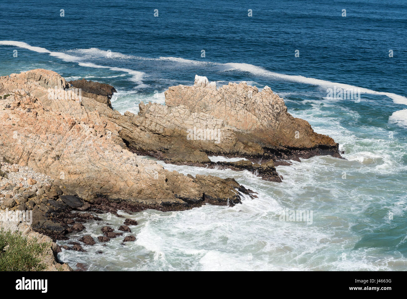 A rocky outcrop, resembling a dragon, in the sea next to Clarence Drive between Gordons Bay and Rooi-Els Stock Photo