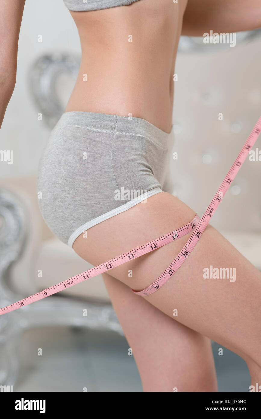 Young woman measuring waist with a tape stock photo (182967) -  YouWorkForThem