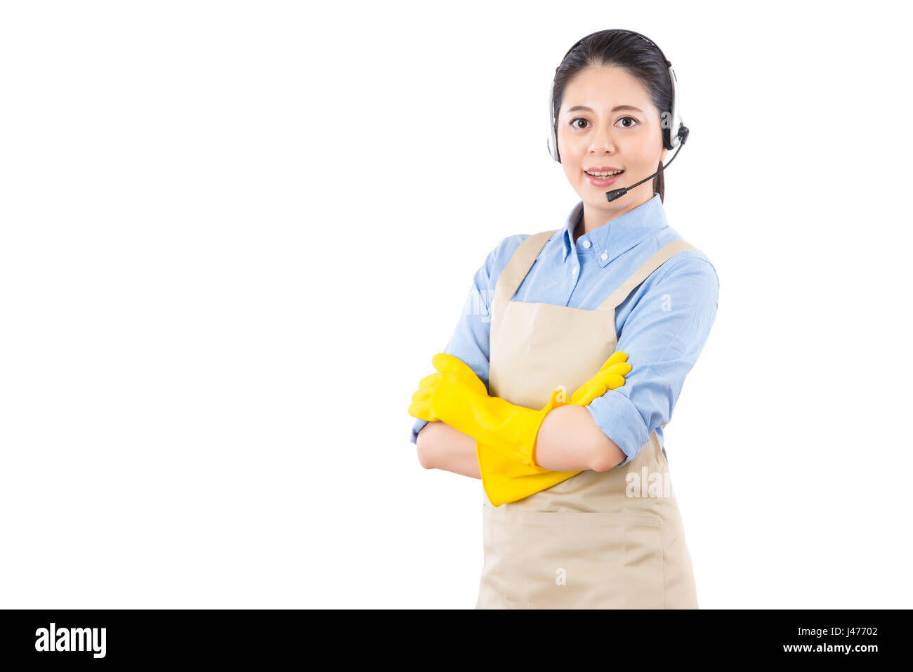 professional house cleaning business woman online services using headset microphone. isolated on white background. mixed race asian chinese model. Stock Photo