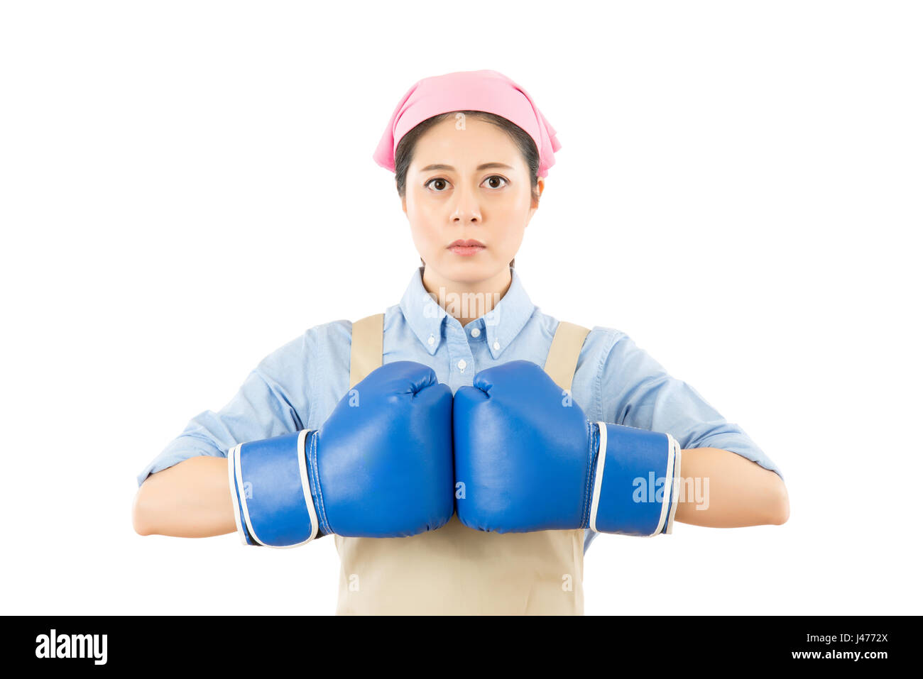 aggressive young mixed race Chinese Asian woman punching blue boxing gloves together. isolated on white background. housework and household idea conce Stock Photo