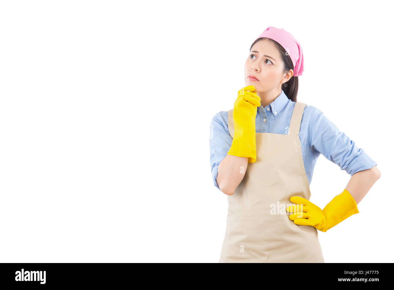 mixed race Asian lady thinking cleaning woman looking away pensive. Beautiful cute cleaning girl wearing cleaning rubber gloves isolated on white back Stock Photo