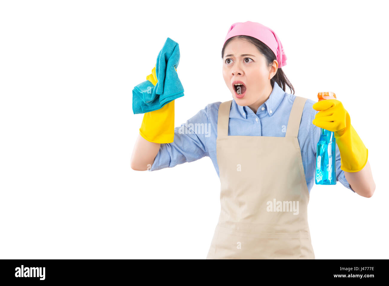 cute multiracial female spring cleaning woman shocked. Funny cleaning lady stressed wearing rubber gloves holding detergent spray. isolated on white b Stock Photo