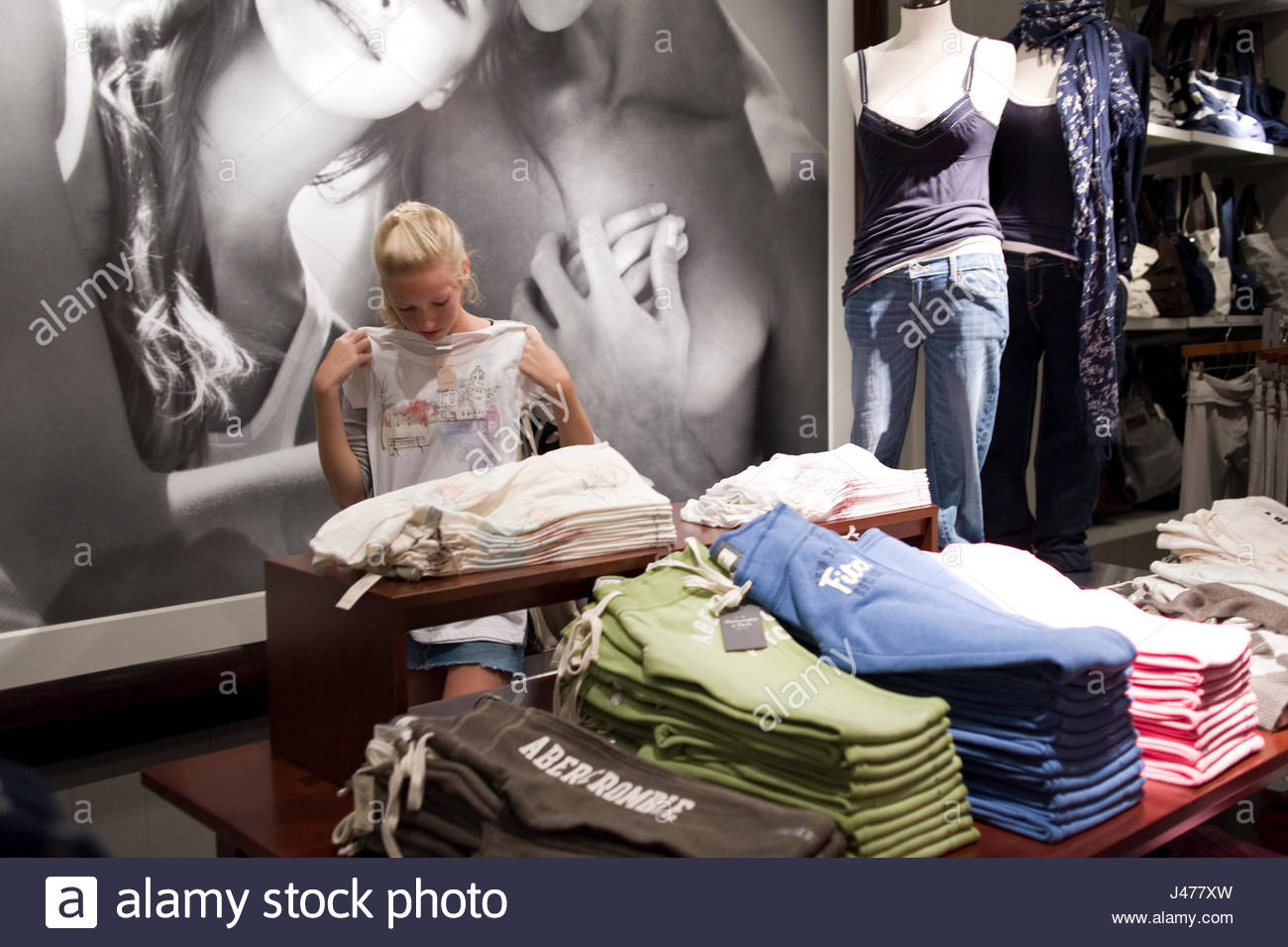 Teenage girl with blonde hair shopping for clothing at Abercrombie ...