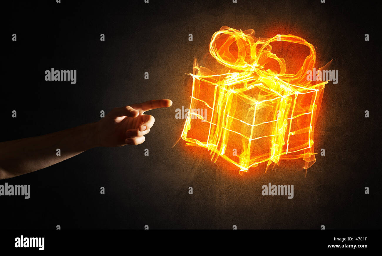 glowing-fire-gift-box-icon-in-palm-on-dark-background-J4781P.jpg