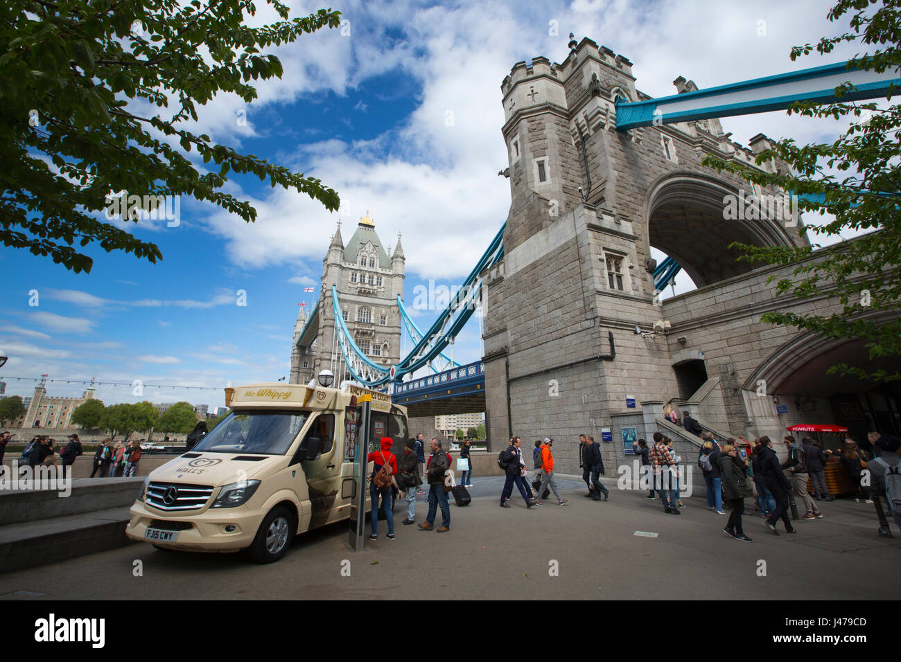 Ice cream vendor selling ice creams next to London Tower Bridge, viewed