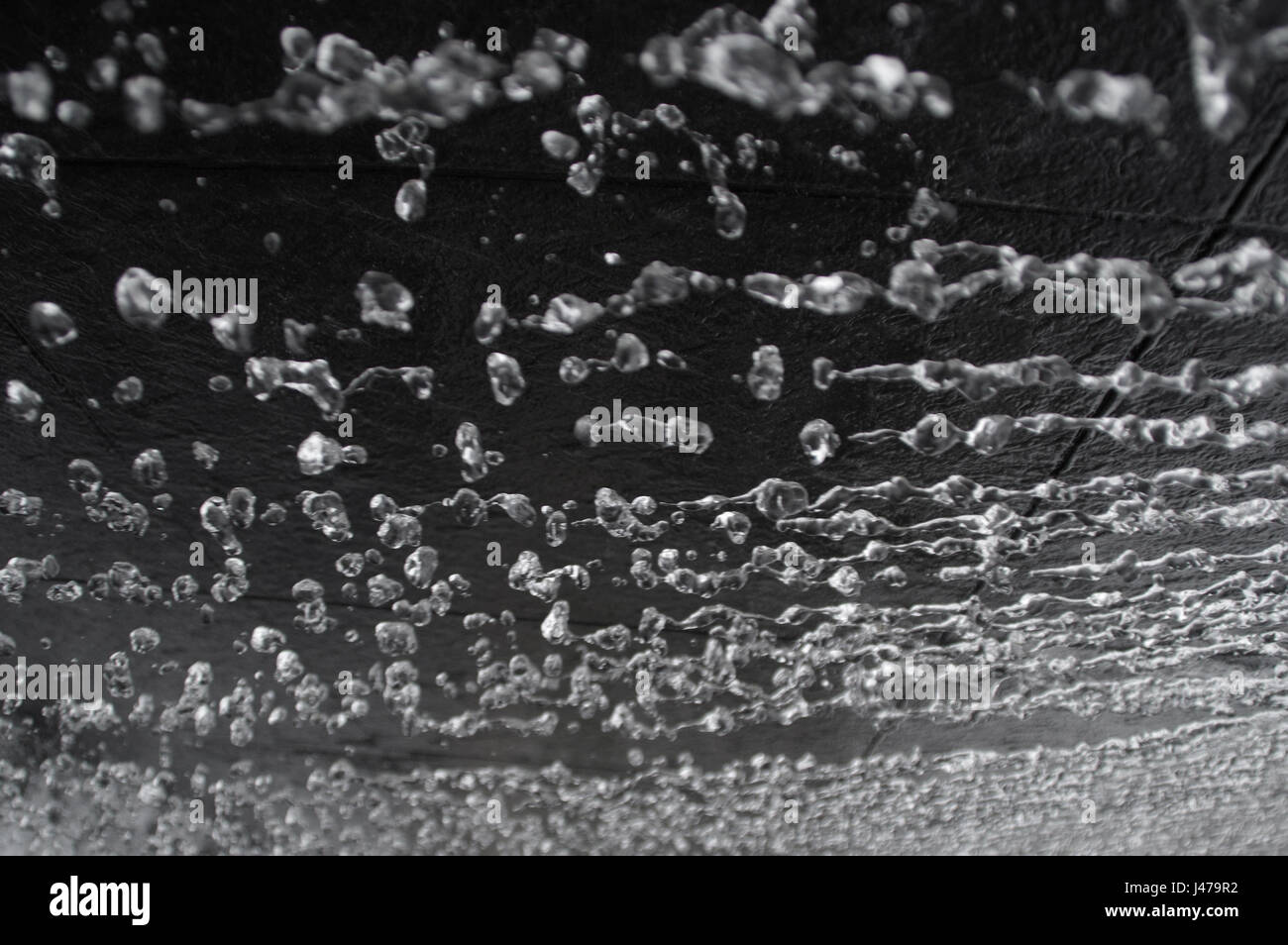 Weightlessness water droplets on dark background Stock Photo