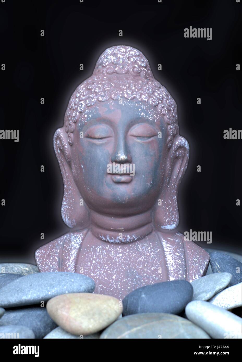 Bust of Buddha. Statue of Buddha with pebble stones. River stones, Sea